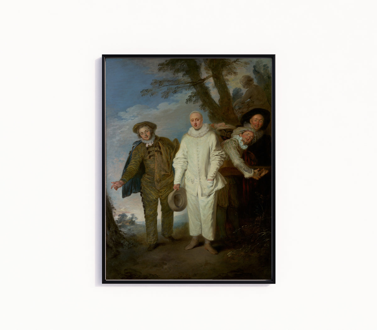 Framed art print of The Italian Comedians by Jean-Antoine Watteau, in a slim black frame on a plain white wall