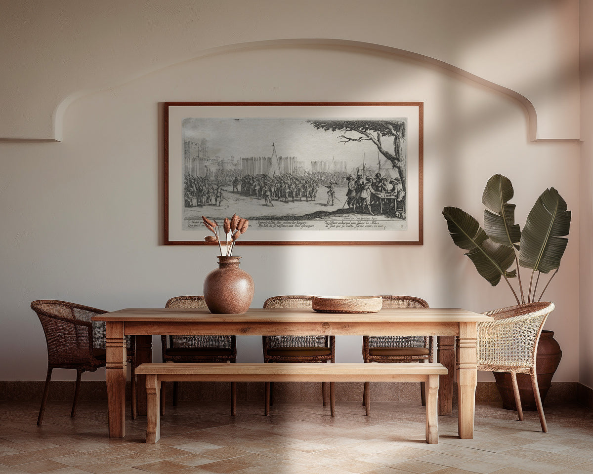 Framed art print of The Large Miseries of War: Enrollment of the Troops by Jacques Callot, above a wooden dining table