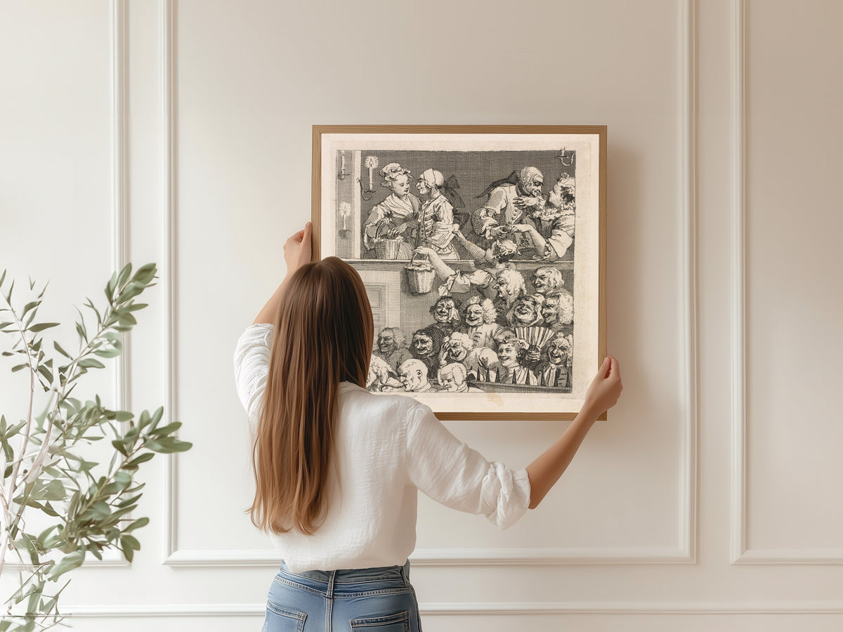 Framed art print of The Laughing Audience by William Hogarth, hung on a panelled wall