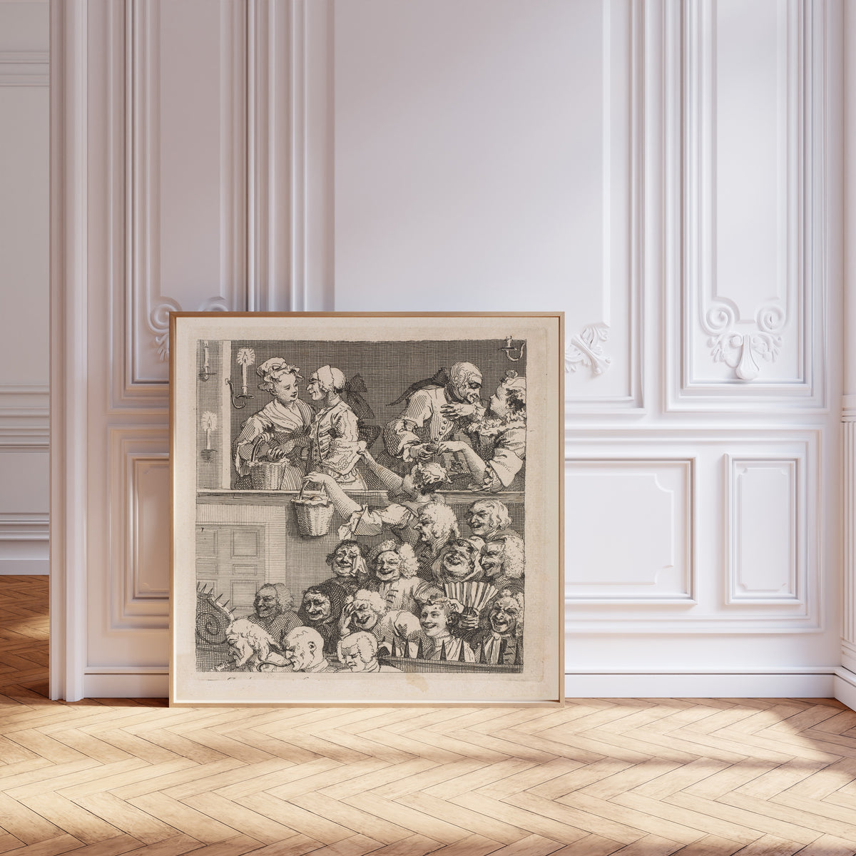 Framed art print of The Laughing Audience by William Hogarth, leaning against pale pink panelling on a herringbone floor