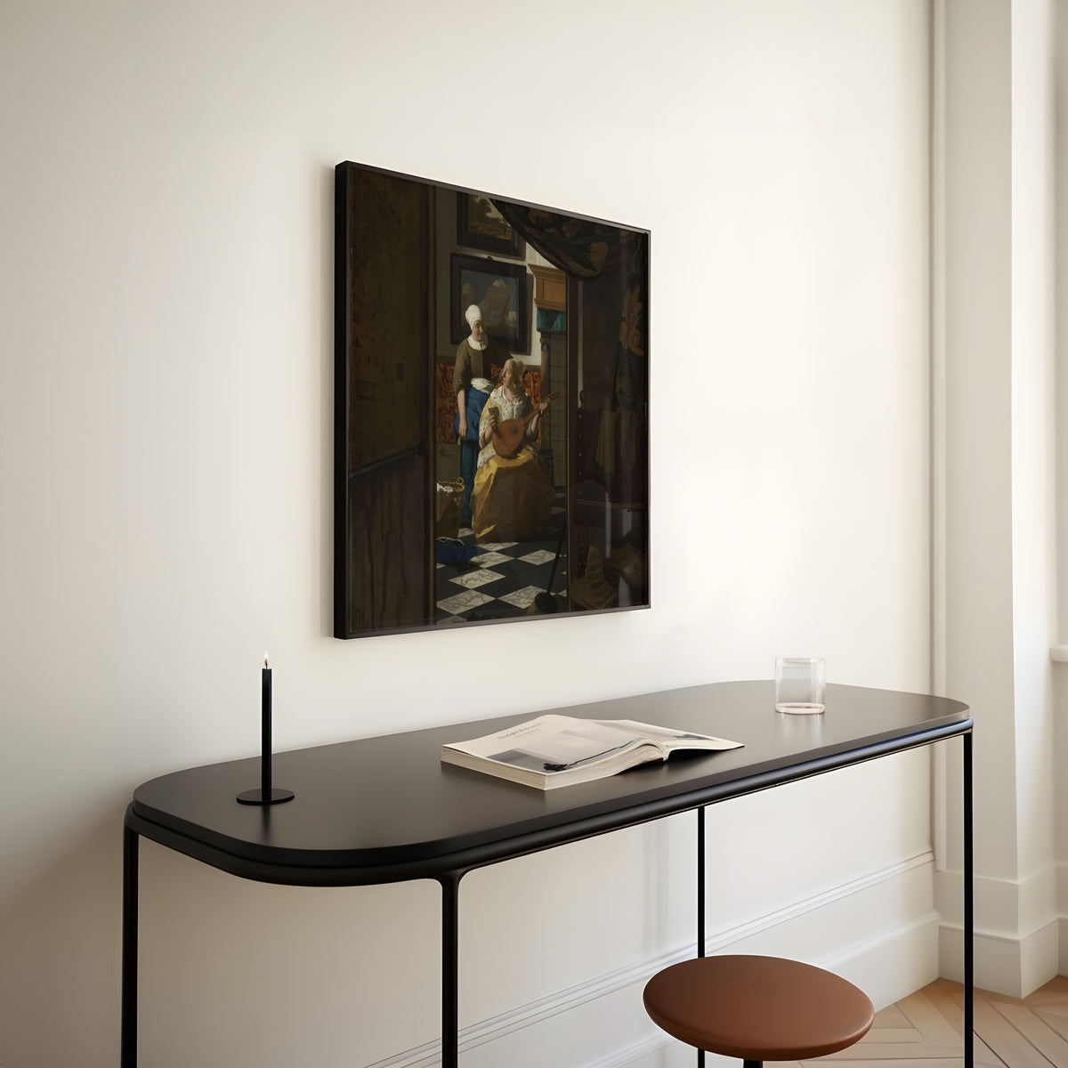Framed art print of The Love Letter by Johannes Vermeer, above a slim black console table