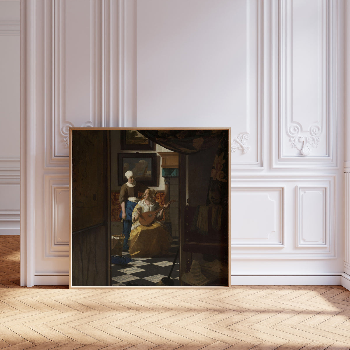 Framed art print of The Love Letter by Johannes Vermeer, leaning against pale pink panelling on a herringbone floor