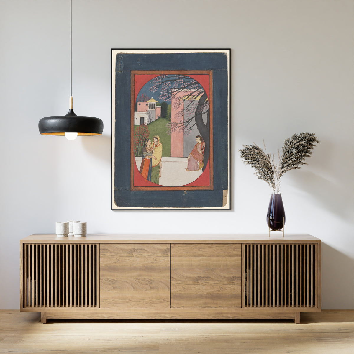 Framed art print of The Lovelorn Heroine by Pahari school, above a slatted wood sideboard