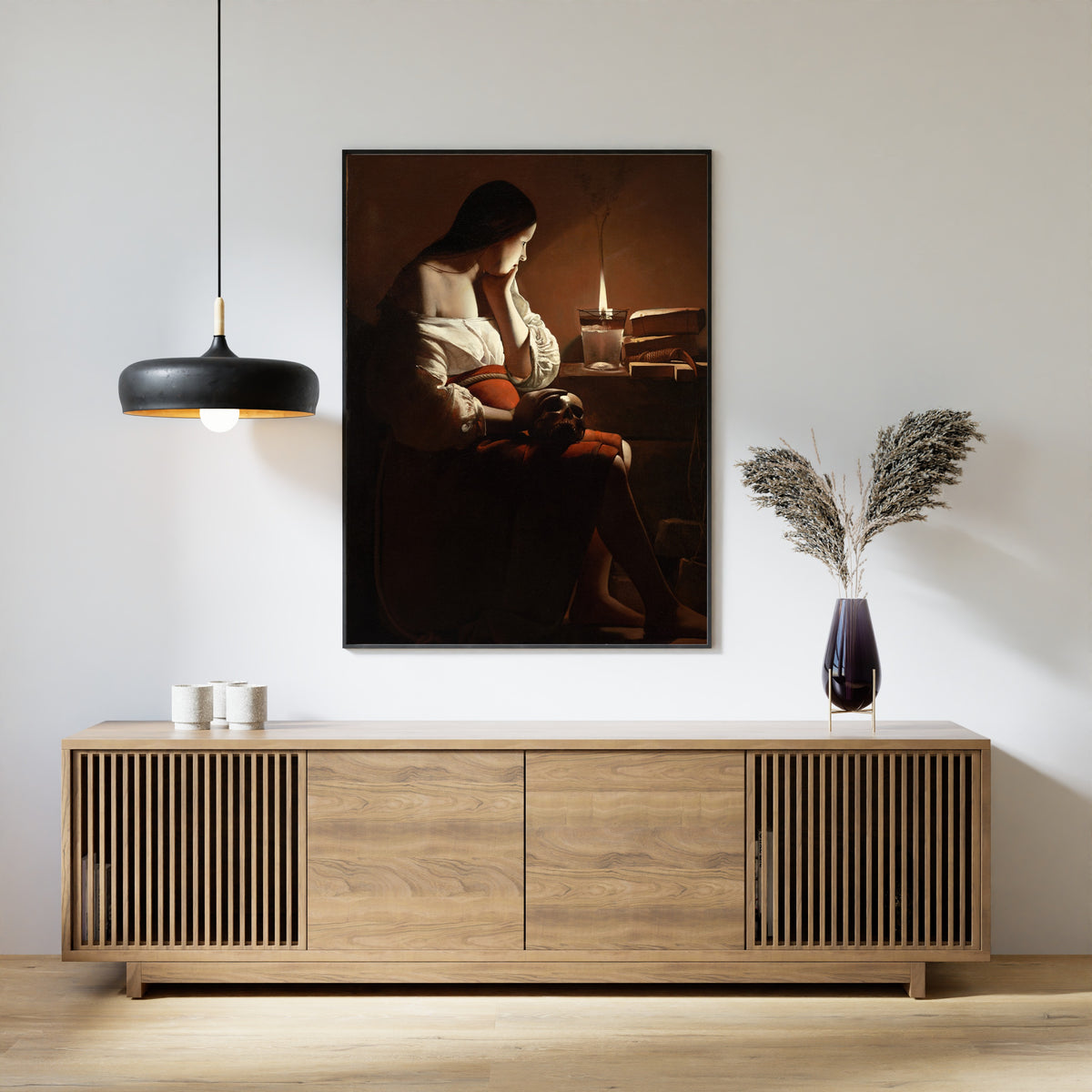 Framed art print of The Magdalen with the Smoking Flame by Georges de La Tour, above a slatted wood sideboard