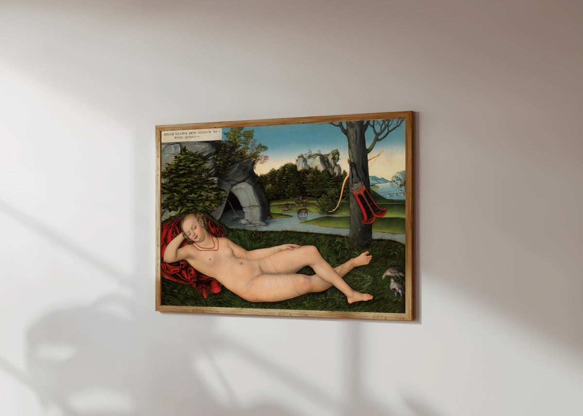 Framed art print of The Nymph of the Spring by Lucas Cranach the Elder, in a light wood frame on a sunlit white wall, seen at a slight angle