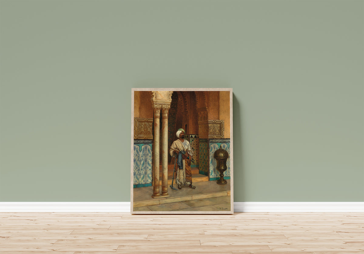 Framed art print of The Palace Guard by Rudolf Ernst, in a light wood frame leaning on a sage green wall above a wooden floor