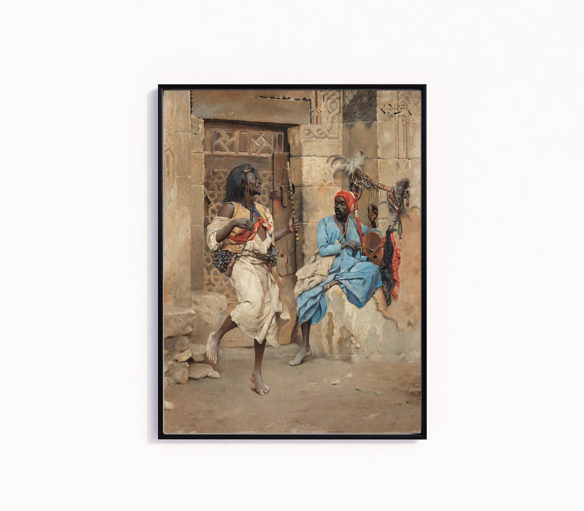 Framed art print of The Performance by Ludwig Deutsch, in a slim black frame on a plain white wall