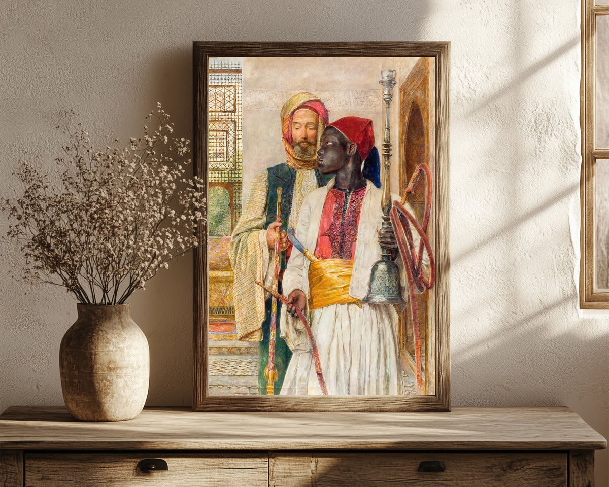 Framed art print of The Pipe Bearer by John Frederick Lewis, in a dark wood frame leaning on a rustic console beside dried flowers