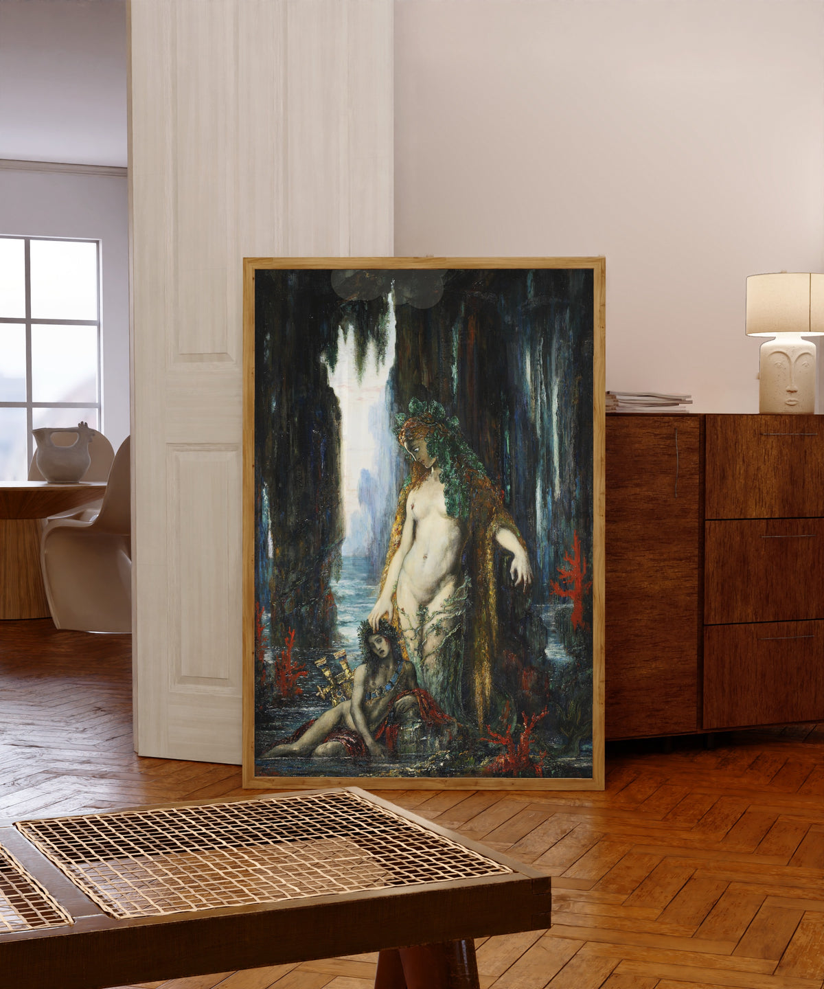 Framed art print of The Poet and the Siren by Gustave Moreau, in a light wood frame leaning in a warm room with a parquet floor