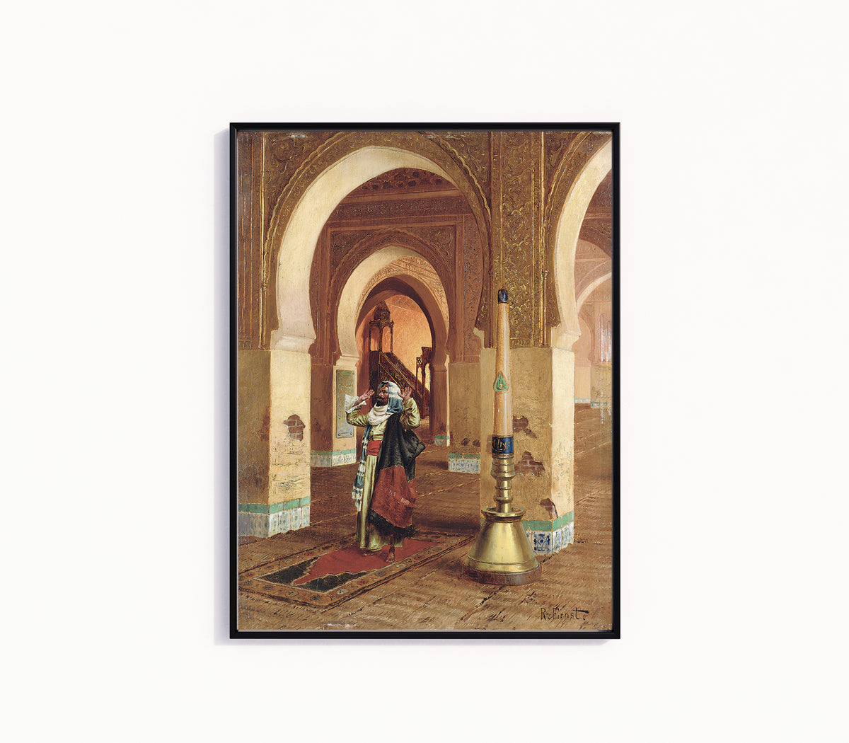 Framed art print of The Prayer by Rudolf Ernst, in a slim black frame on a plain white wall