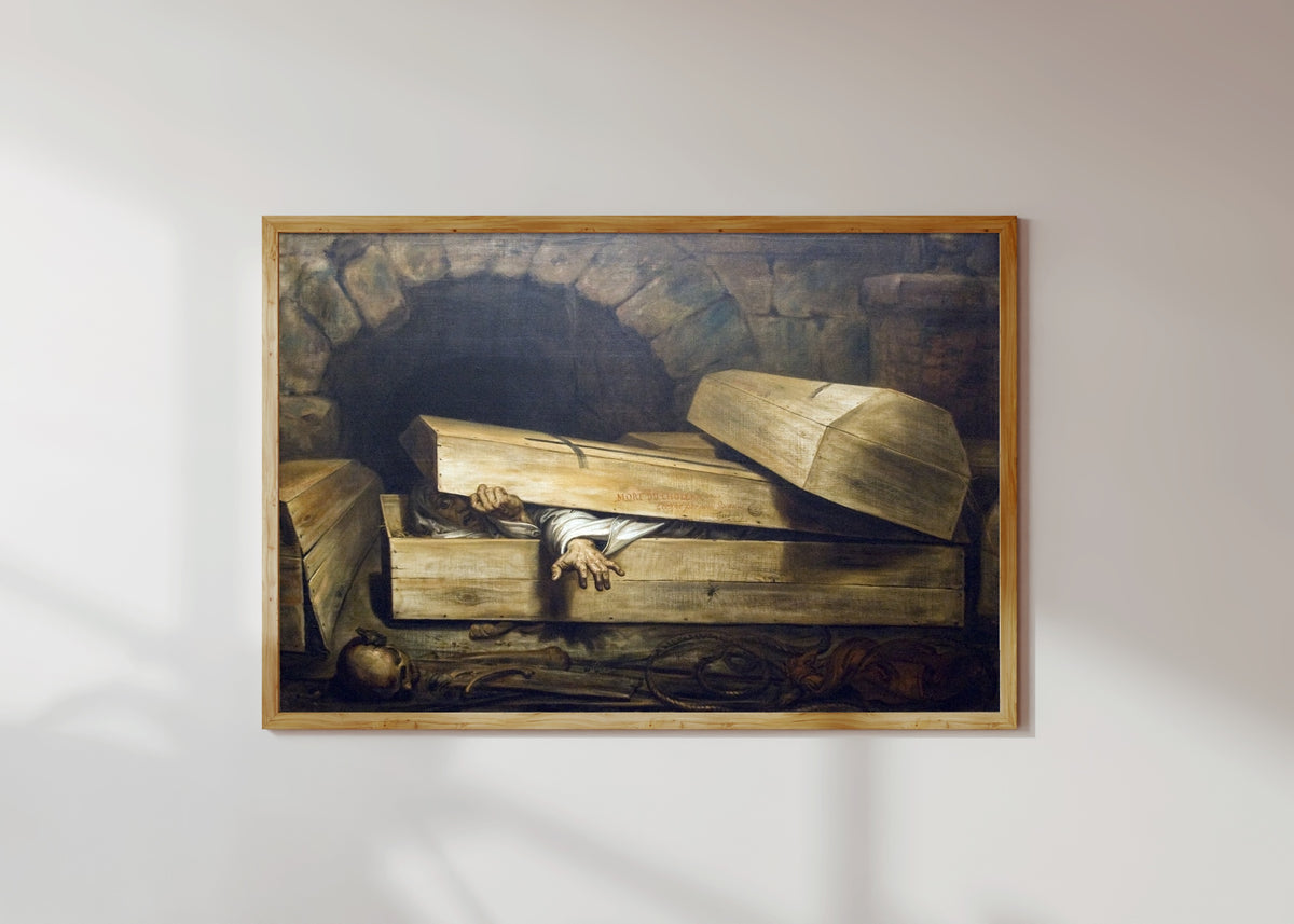 Framed art print of The Premature Burial by Antoine Wiertz, in a light wood frame on a sunlit white wall