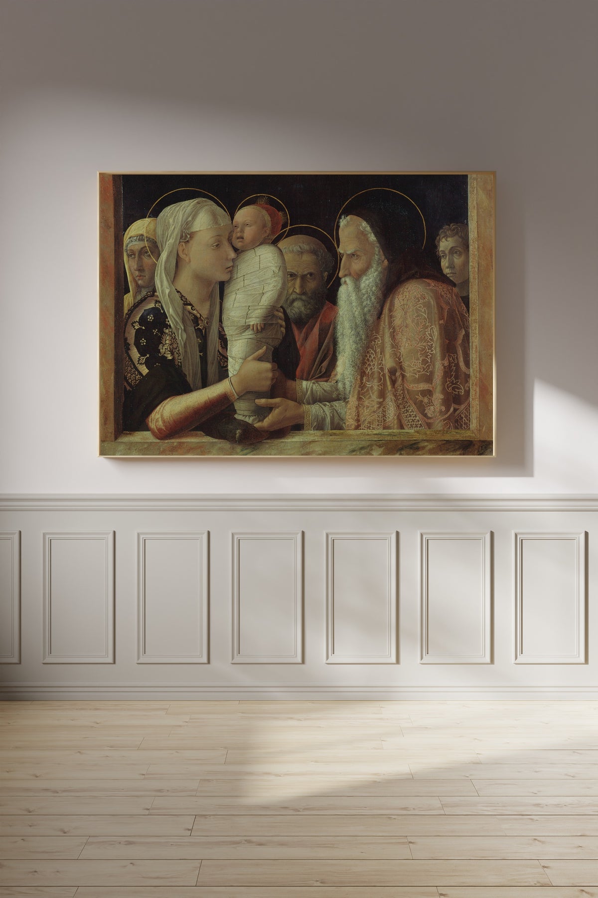 Framed art print of The Presentation by Andrea Mantegna, on a panelled wall in afternoon light