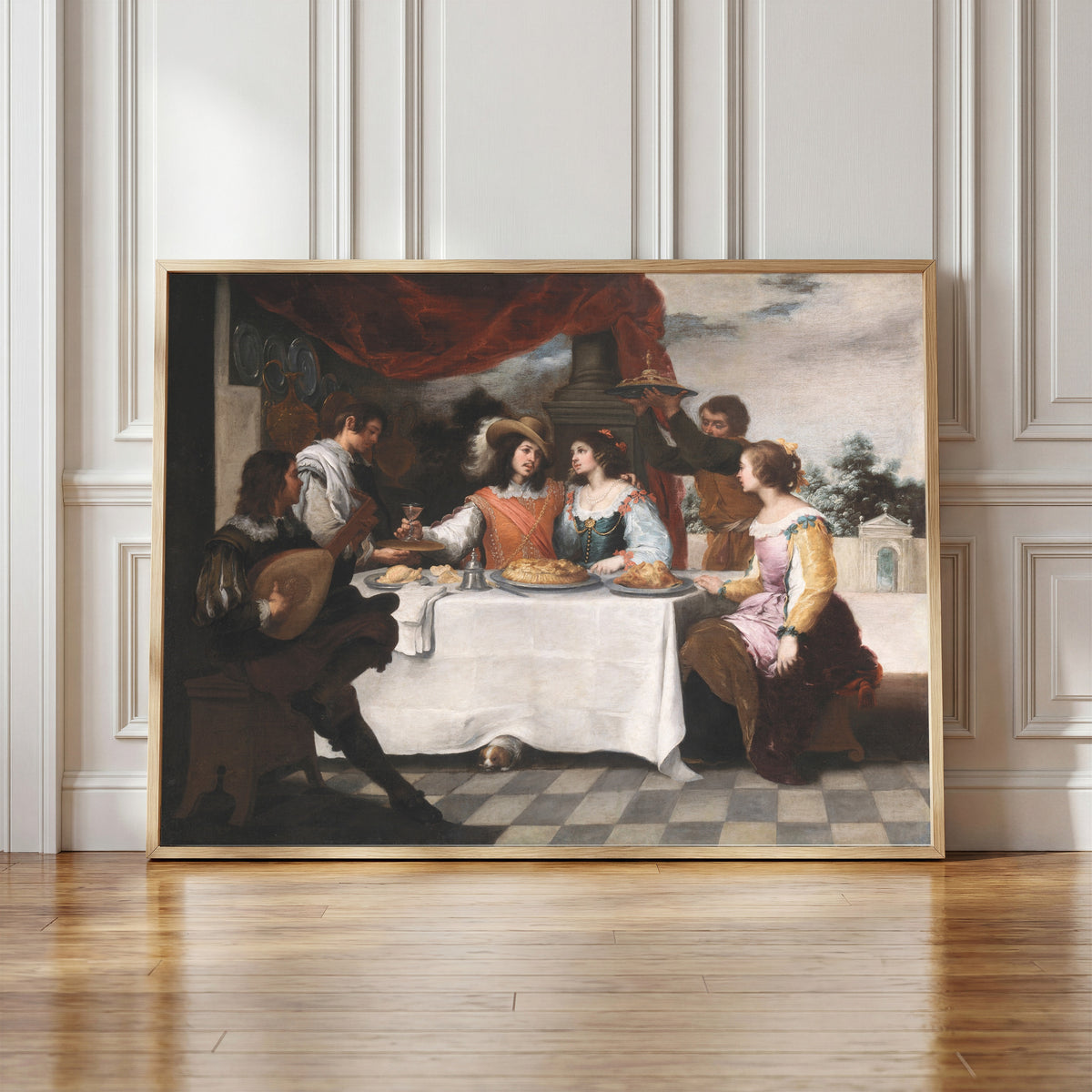 Framed art print of The Prodigal Son Feasting by Bartolomé Esteban Murillo, in a light wood frame leaning against a panelled white wall