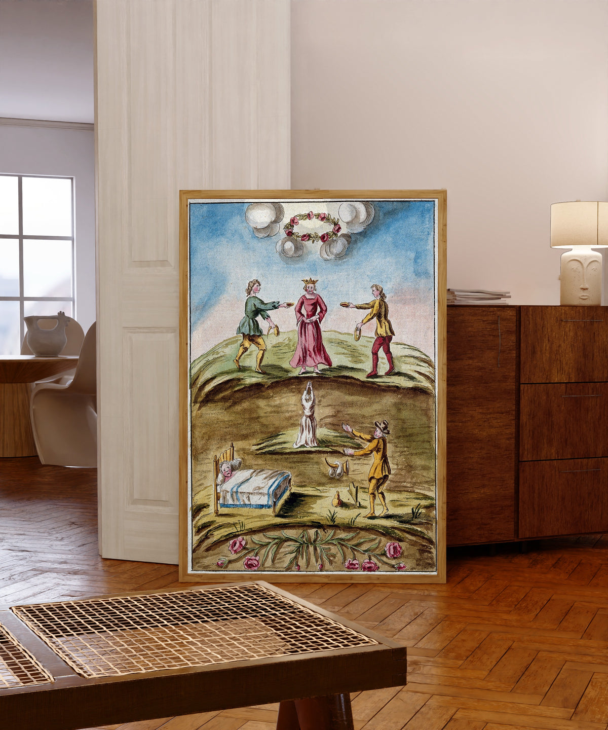 Framed art print of The Queen Presented with Dishes of Blood by After Nicolas Flamel, in a light wood frame leaning in a warm room with a parquet floor