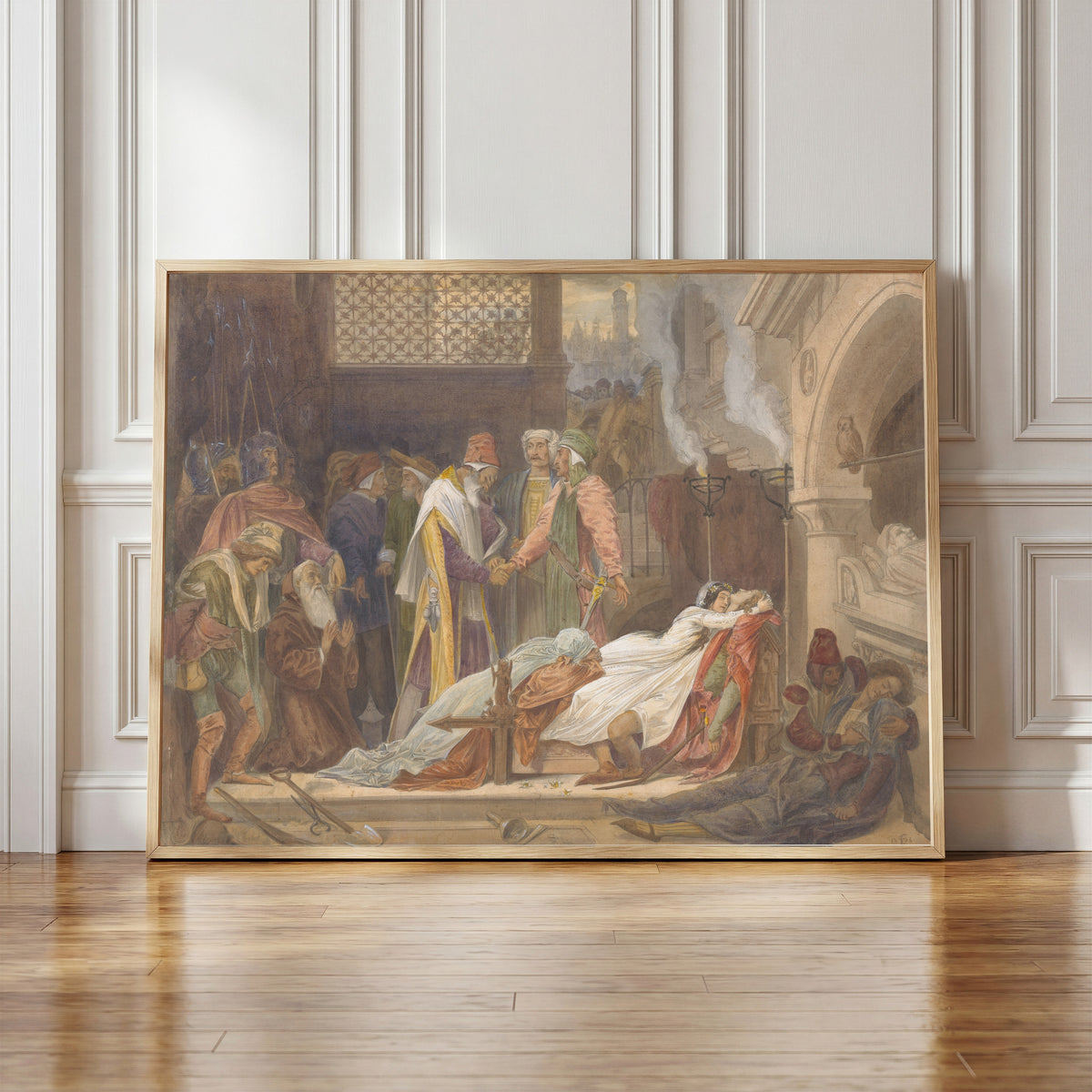 Framed art print of The Reconciliation of the Montagues and the Capulets by Frederic Leighton, in a light wood frame leaning against a panelled white wall