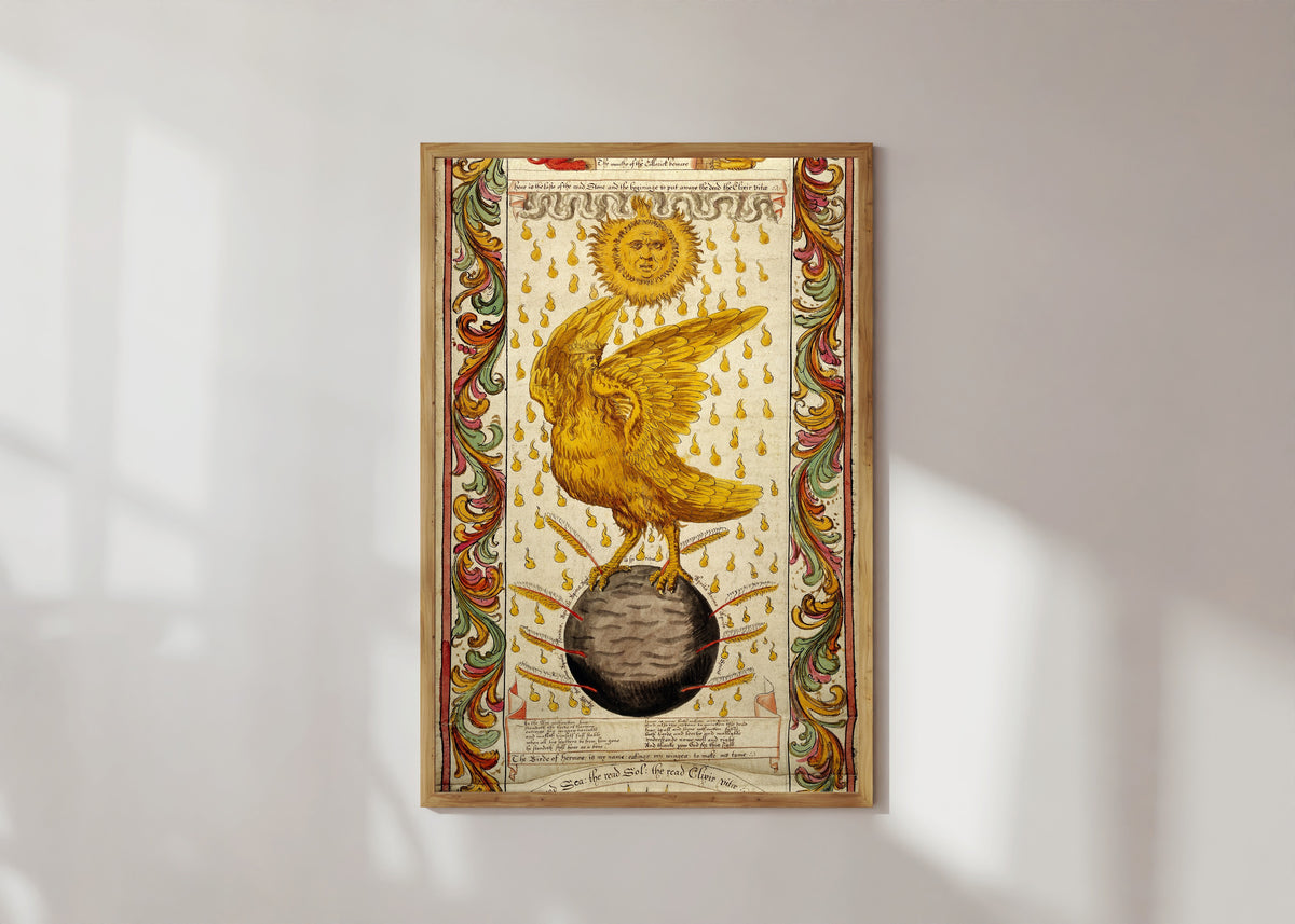 Framed art print of The Ripley Scroll: The Golden Winged Bird on the Black Earth by George Ripley, in a light wood frame on a sunlit white wall