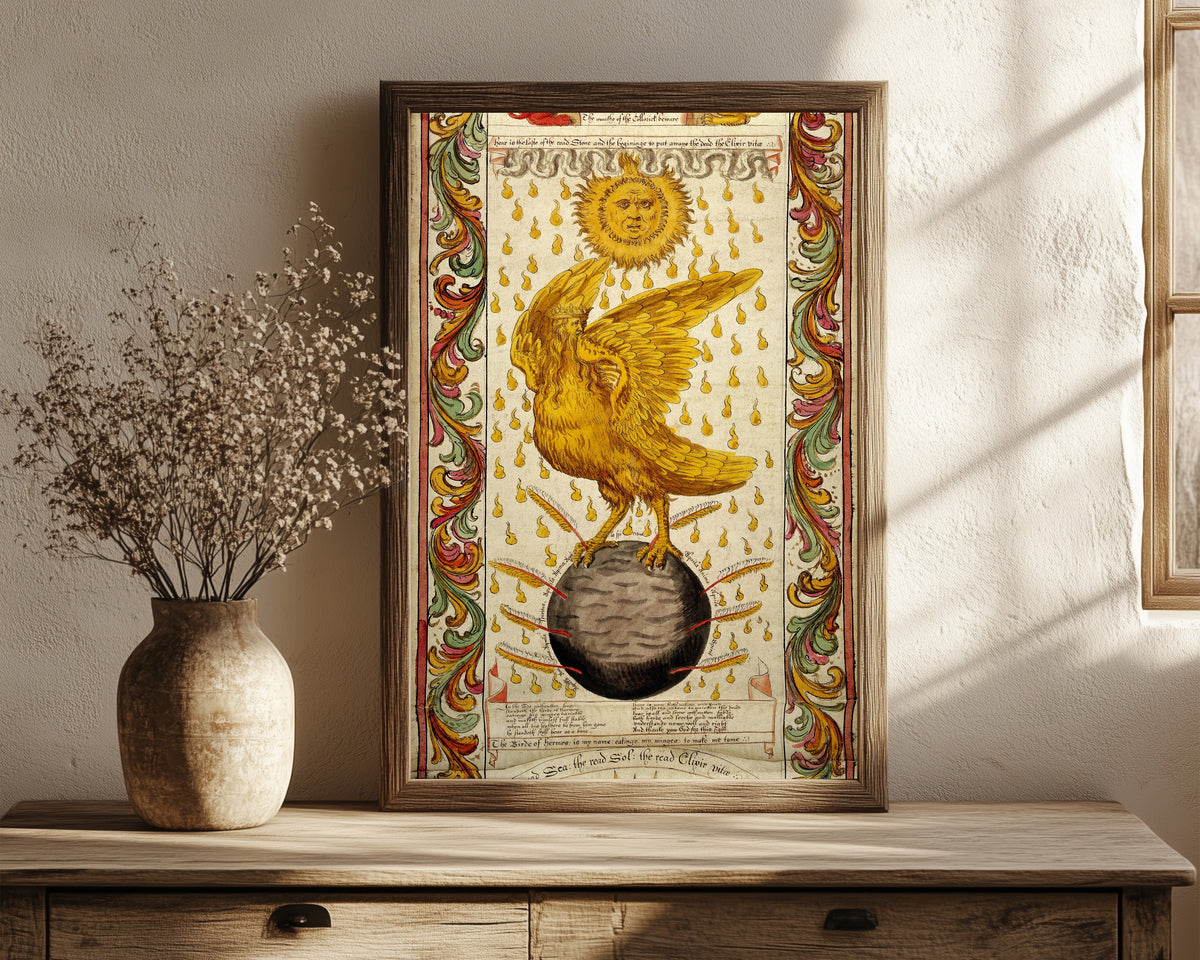Framed art print of The Ripley Scroll: The Golden Winged Bird on the… by George Ripley, in a dark wood frame leaning on a rustic console beside dried flowers