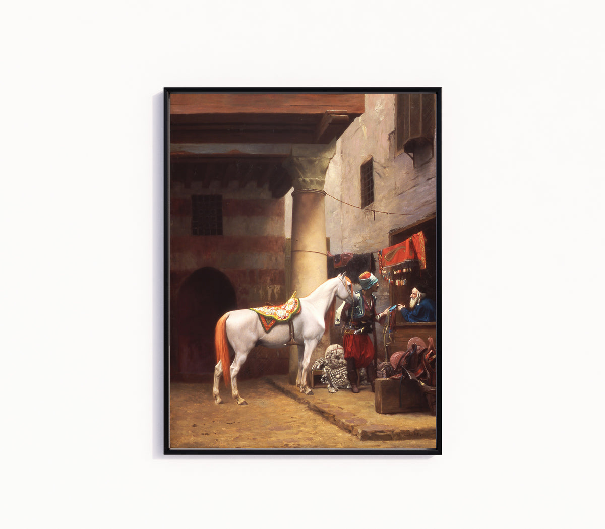 Framed art print of The Saddle Bazaar, Cairo by Jean-Léon Gérôme, in a slim black frame on a plain white wall