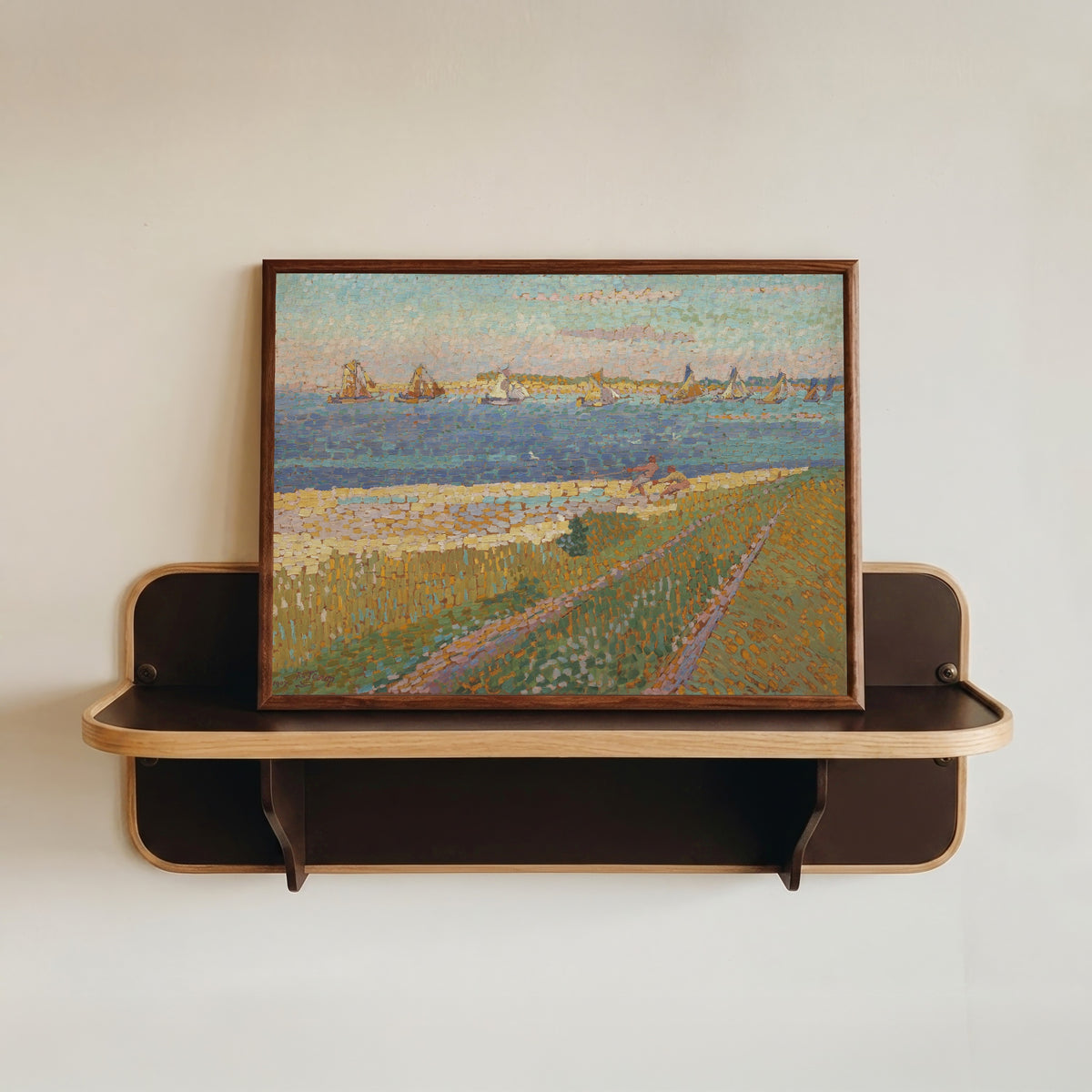 Framed art print of The Schelde near Veere by Jan Toorop, in a dark wood frame resting on a wall shelf