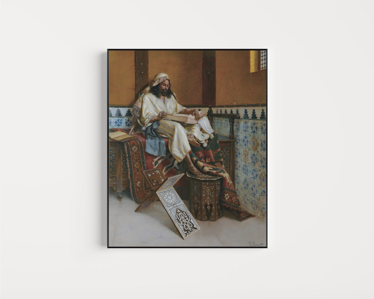 Framed art print of The Scholar by Rudolf Ernst, in a slim black frame on a plain white wall
