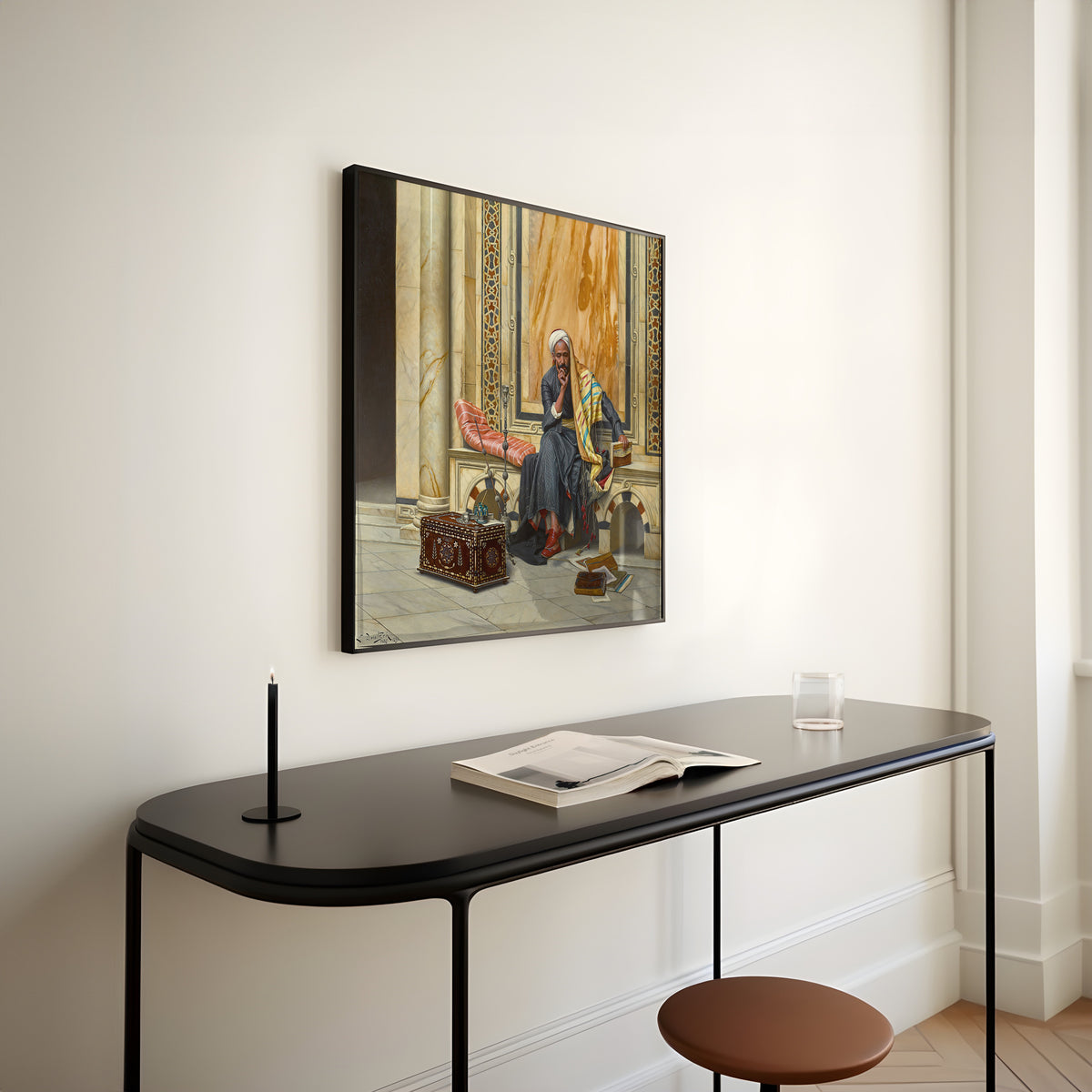 Framed art print of The Scribe by Ludwig Deutsch, above a slim black console table