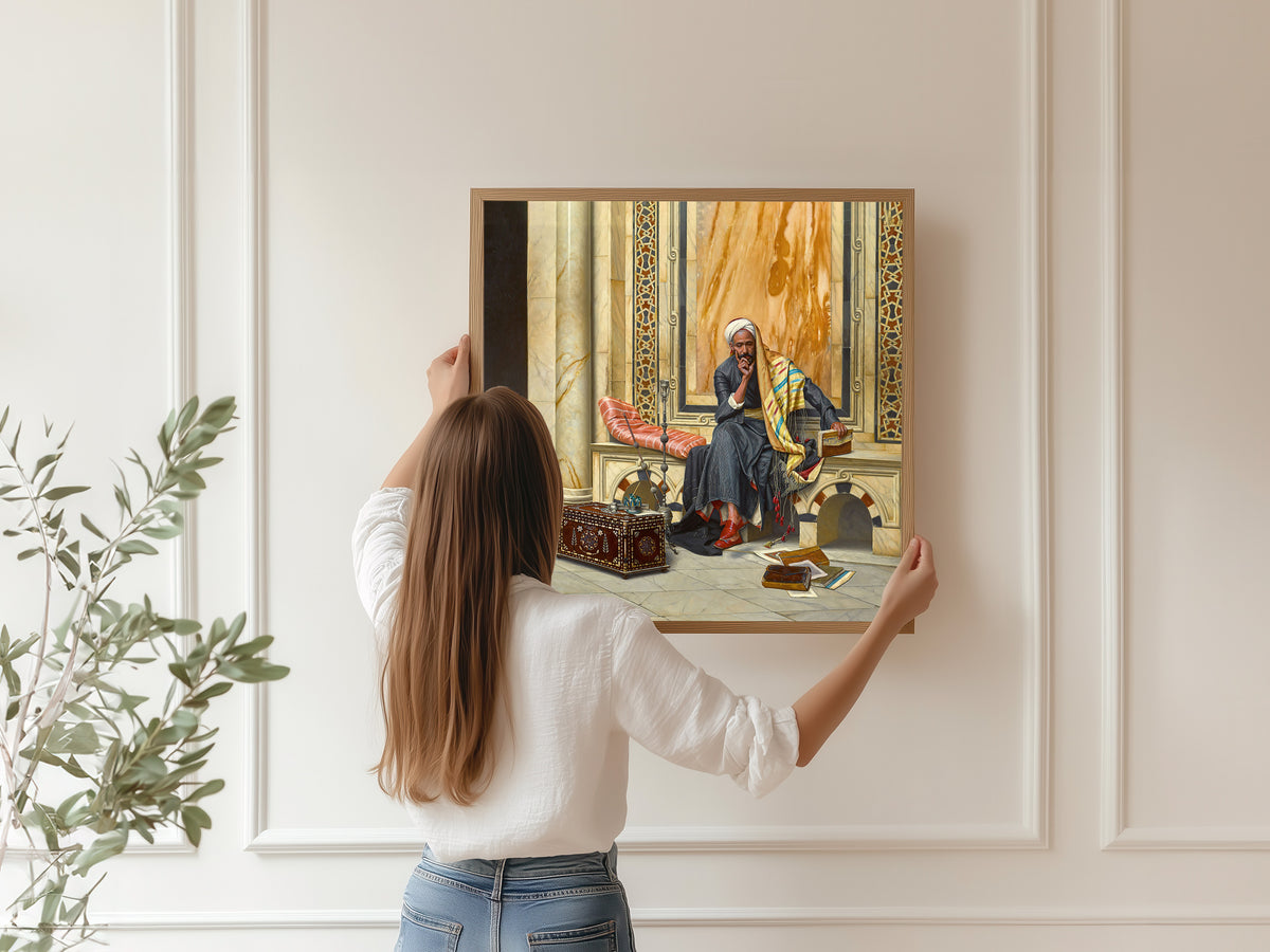 Framed art print of The Scribe by Ludwig Deutsch, hung on a panelled wall