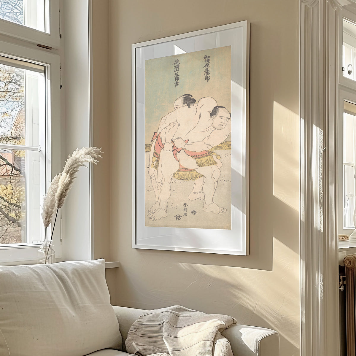 Framed art print of The Sumo Wrestlers Wadagahara Jinshirō and Kachōzan Gorokichi by Katsushika Hokusai, in a sunlit living room above a sofa