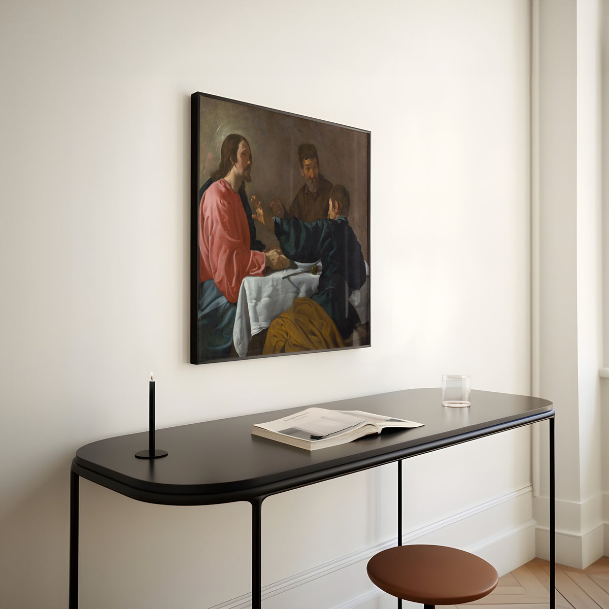 Framed art print of The Supper at Emmaus by Diego Velázquez, above a slim black console table