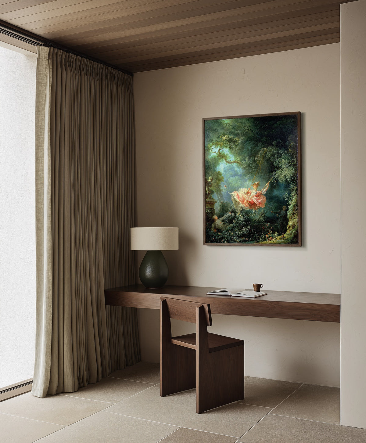 Framed art print of The Swing by Jean-Honoré Fragonard, in a dark wood frame on a plaster wall above a walnut desk