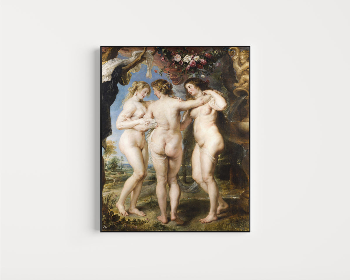 Framed art print of The Three Graces by Peter Paul Rubens, in a slim black frame on a plain white wall