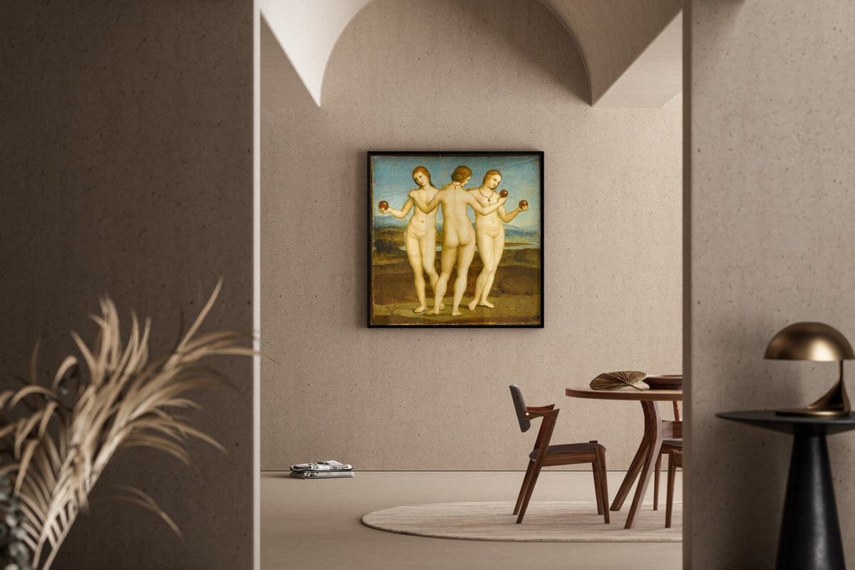 Framed art print of The Three Graces by Raphael, in a sunlit dining corner