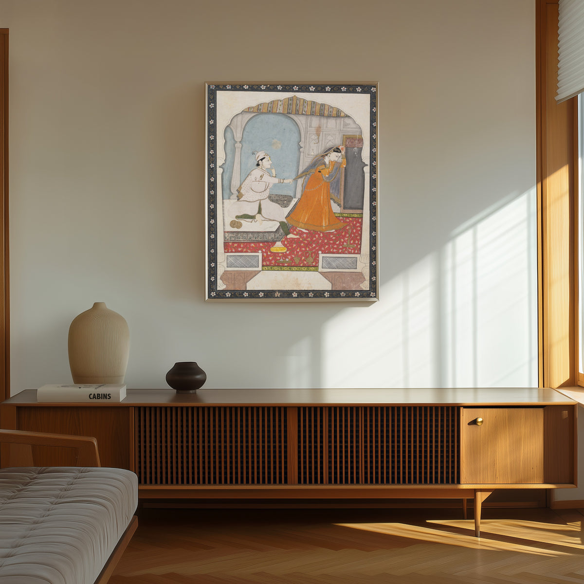 Framed art print of The Timid Bride by Kangra school, in a thin light frame on a sunlit wall above a wooden sideboard