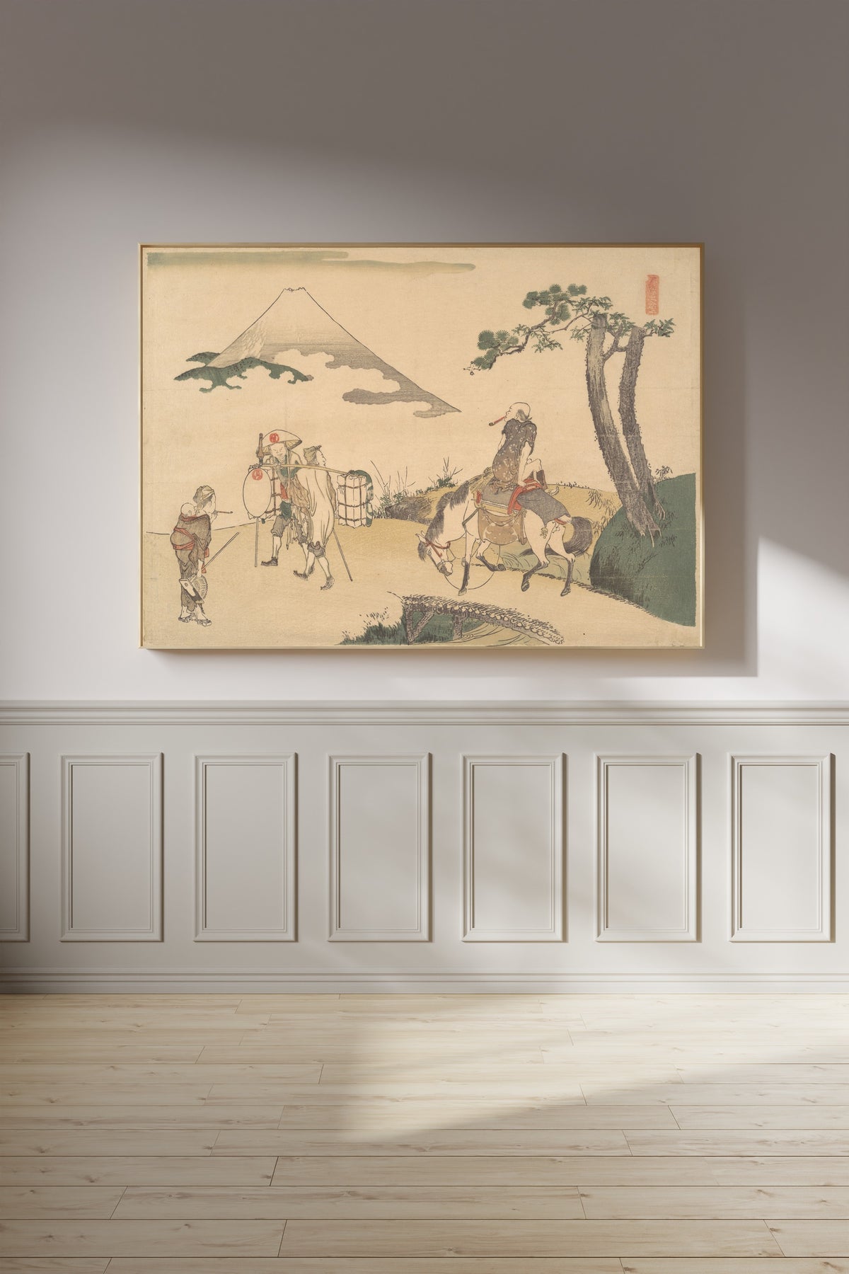 Framed art print of The Top of Mount Fuji by Katsushika Hokusai, on a panelled wall in afternoon light