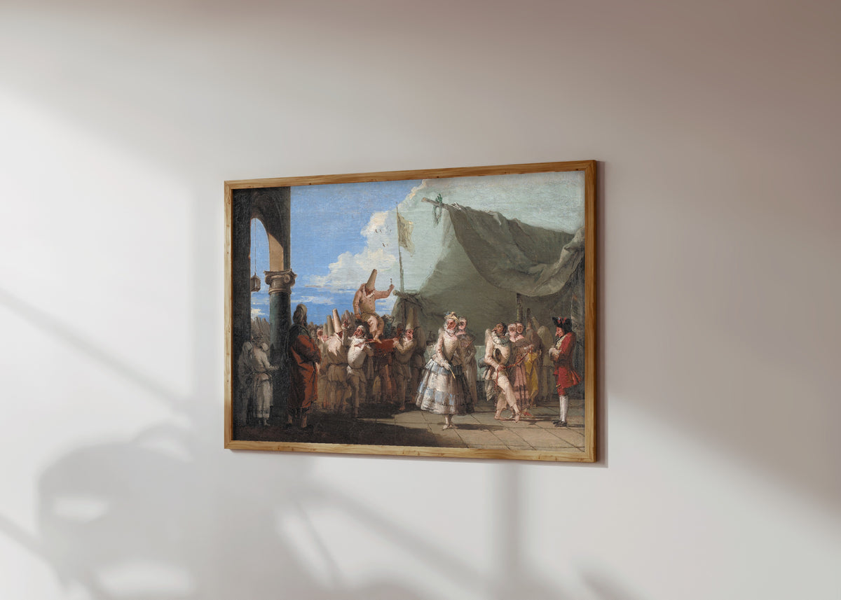 Framed art print of The Triumph of Pulcinella by Giovanni Domenico Tiepolo, in a light wood frame on a sunlit white wall, seen at a slight angle