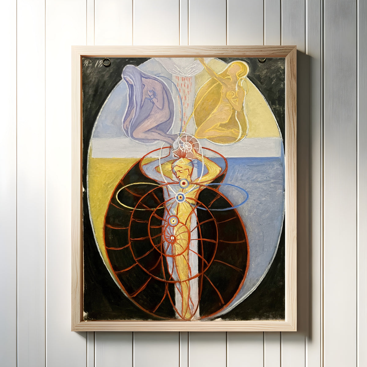 Framed art print of The US Series, Group VIII, No. 1 by Hilma af Klint, in a light wood frame on a white panelled wall