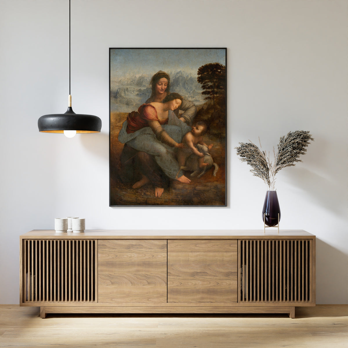 Framed art print of The Virgin and Child with St. Anne by Leonardo da Vinci, above a slatted wood sideboard