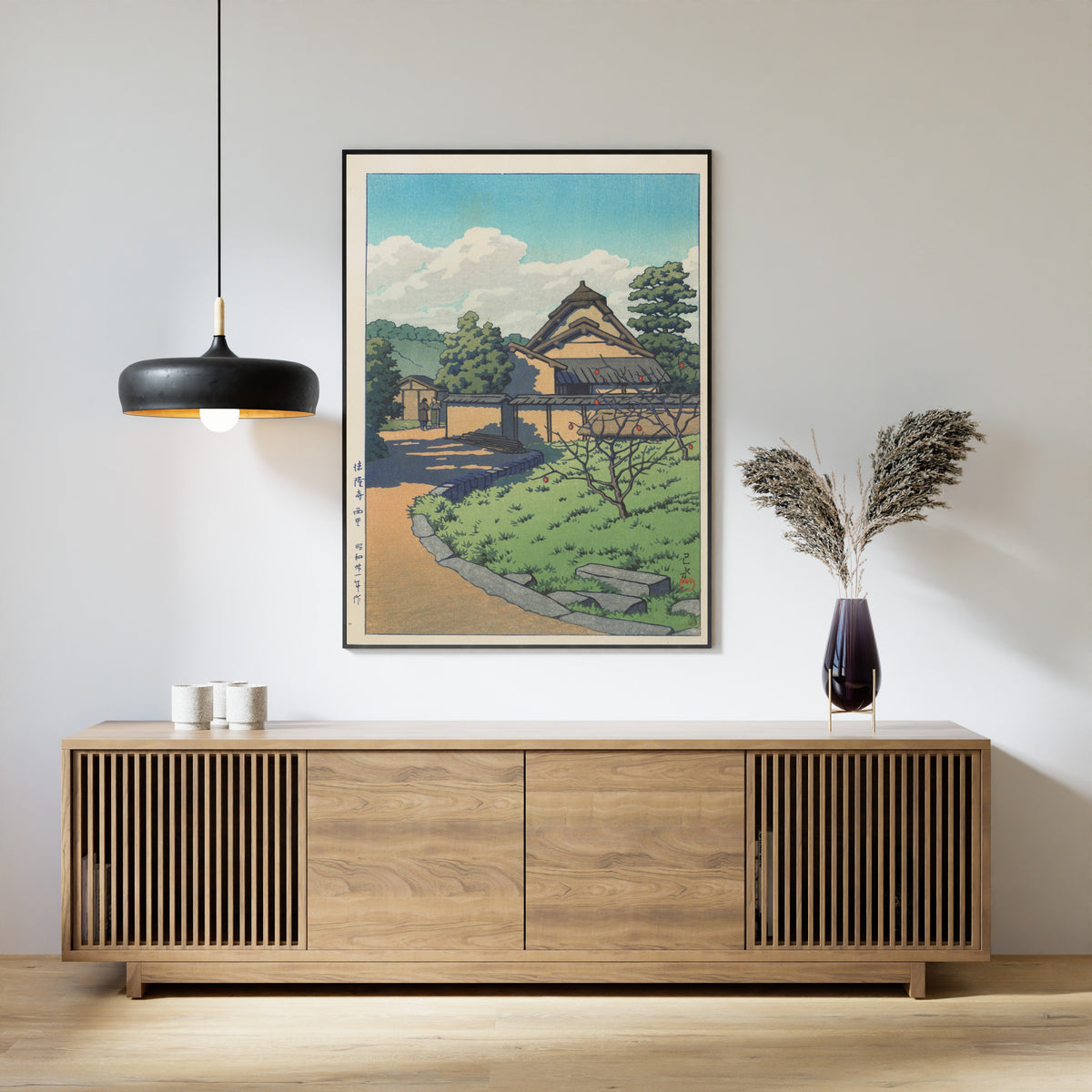 Framed art print of The West Village, Horyuji Temple by Kawase Hasui, above a slatted wood sideboard