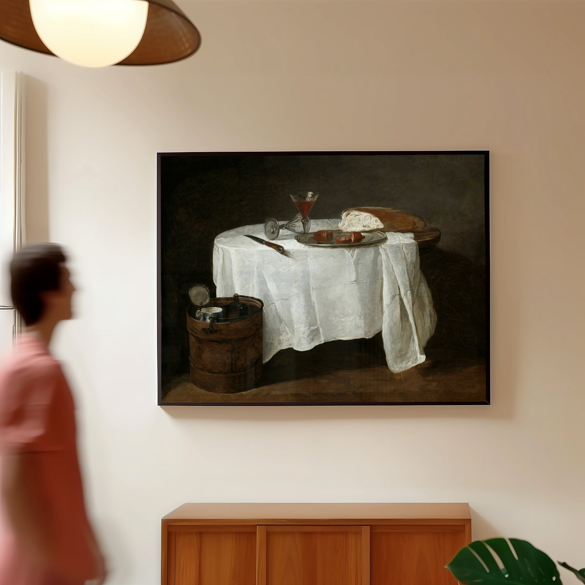 Framed art print of The White Tablecloth by Jean-Siméon Chardin, in a slim black frame on a warm wall in a sunlit room