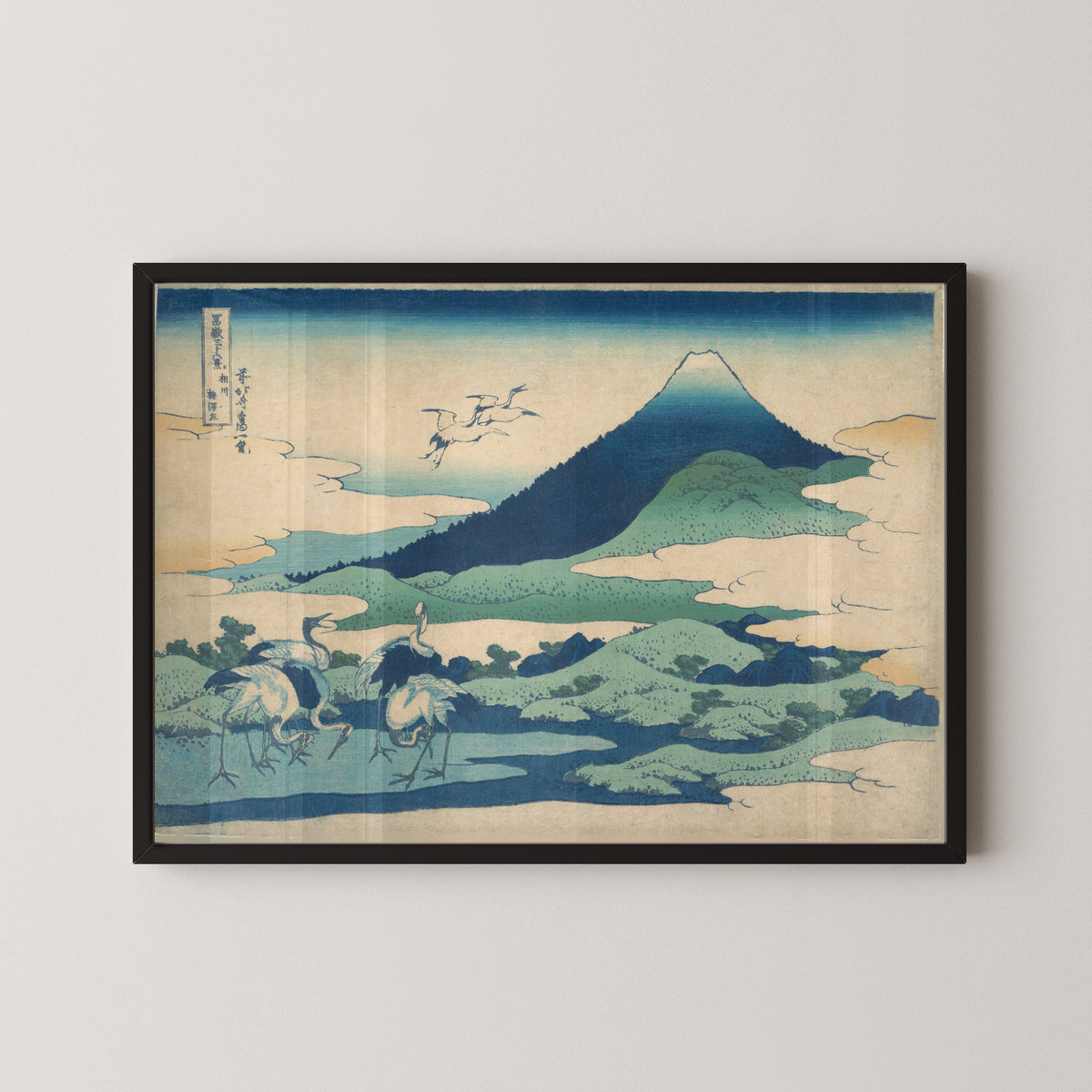 Framed art print of Thirty-six Views of Mount Fuji: Umezawa Manor in Sagami Province by Katsushika Hokusai, in a black frame on a pale wall