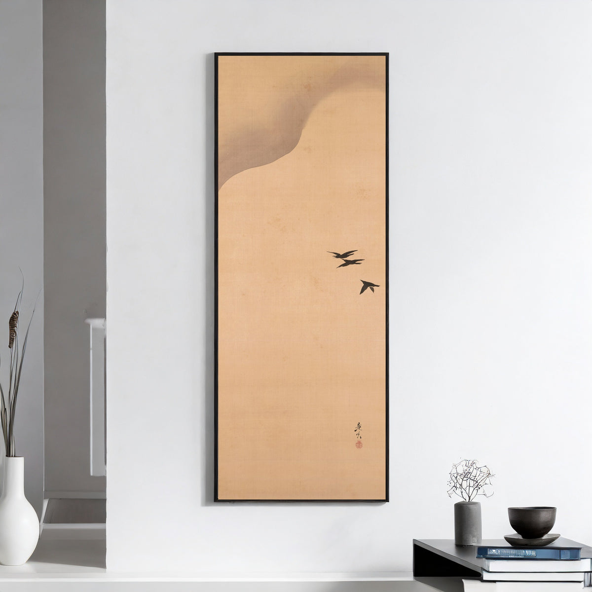 Noh Play Hachinoki, three of three by Shibata Zeshin — framed on a white wall above books and a bowl