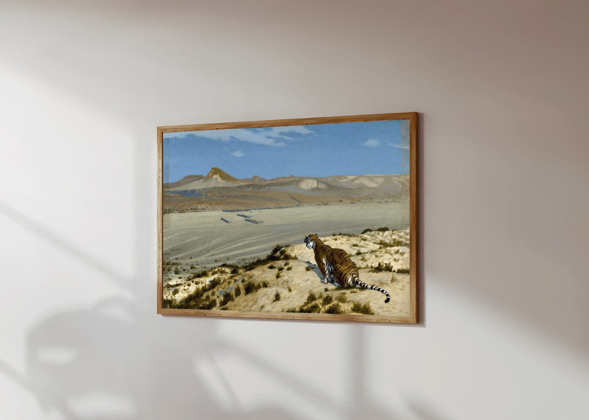 Framed art print of Tiger on the Watch by Jean-Léon Gérôme, in a light wood frame on a sunlit white wall, seen at a slight angle