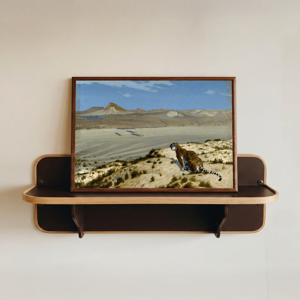 Framed art print of Tiger on the Watch by Jean-Léon Gérôme, in a dark wood frame resting on a wall shelf