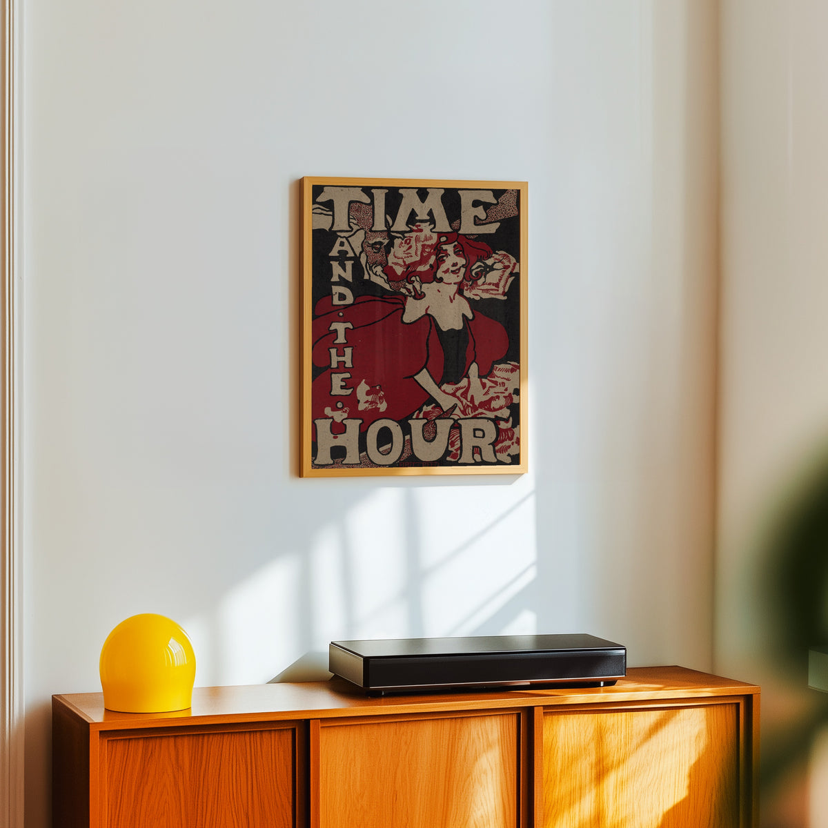 Framed art print of Time and the Hour by Ethel Reed, in a light wood frame on a white wall above an orange sideboard