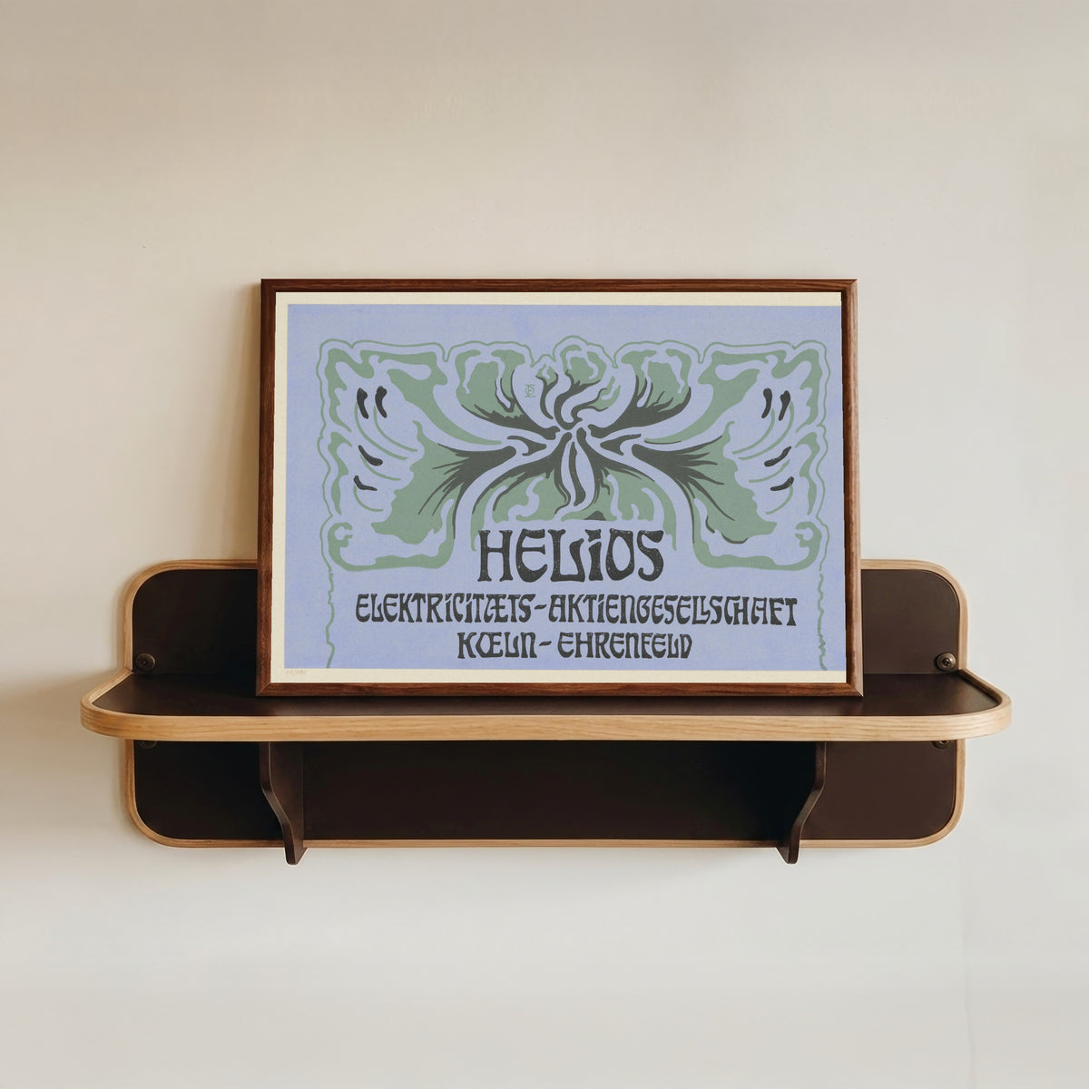 Framed art print of Titelblatt Helios Elektrizitäts-Aktiengesellschaft Köln-Ehrenfeld by Otto Eckmann, in a dark wood frame resting on a wall shelf