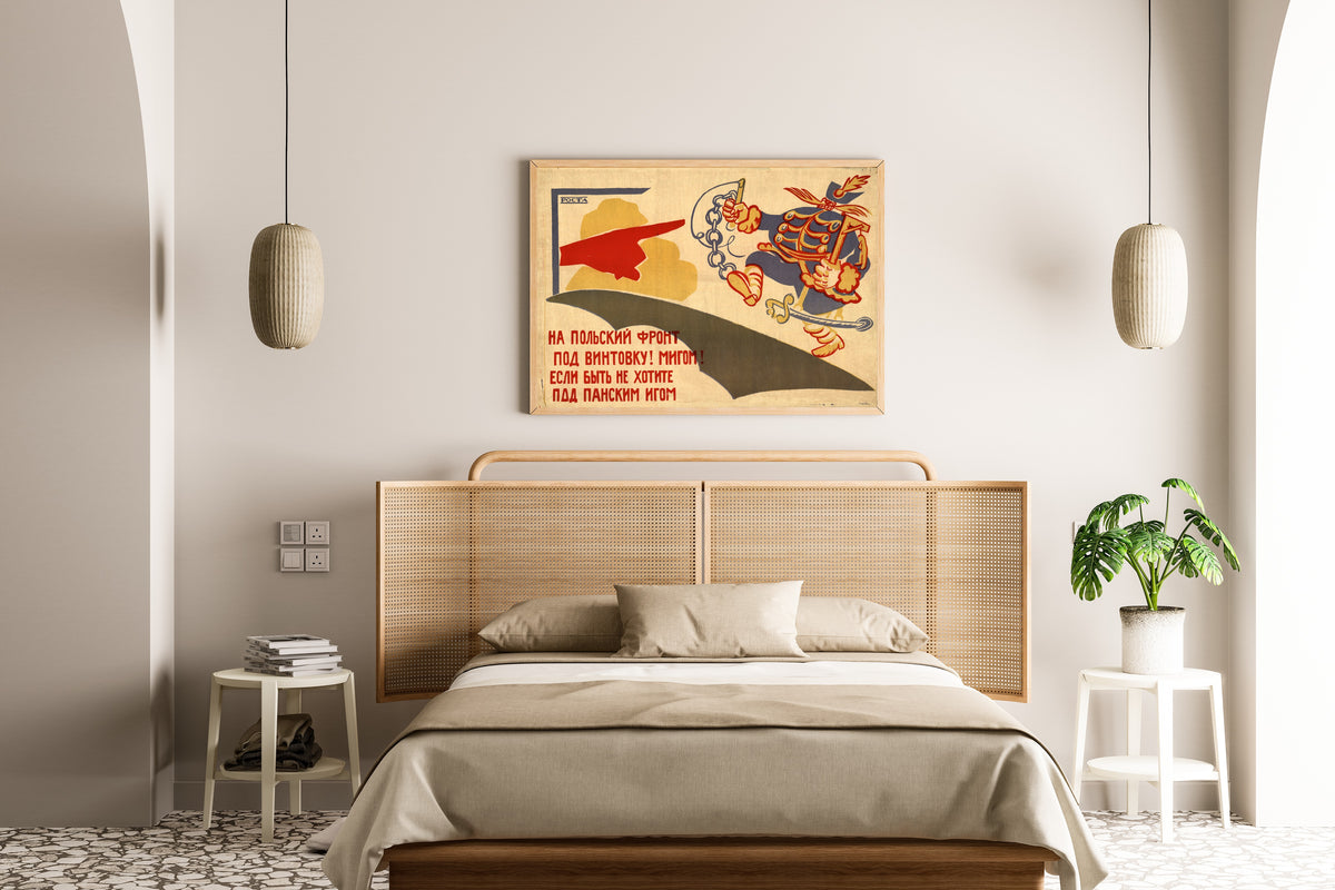 Framed art print of To the Polish Front, Under the Rifle! At Once! by Vladimir Mayakovsky, above a cane-headboard bed