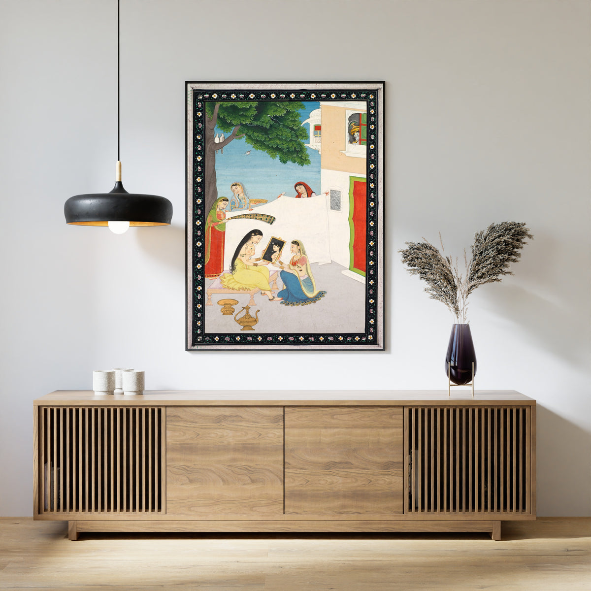 Framed art print of Toilette of Radha by Pahari school, above a slatted wood sideboard