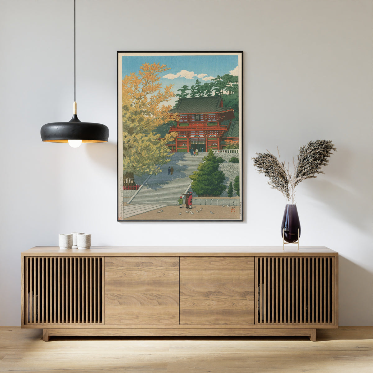 Framed art print of Tsurugaoka Hachimangu Shrine, Kamakura by Kawase Hasui, above a slatted wood sideboard