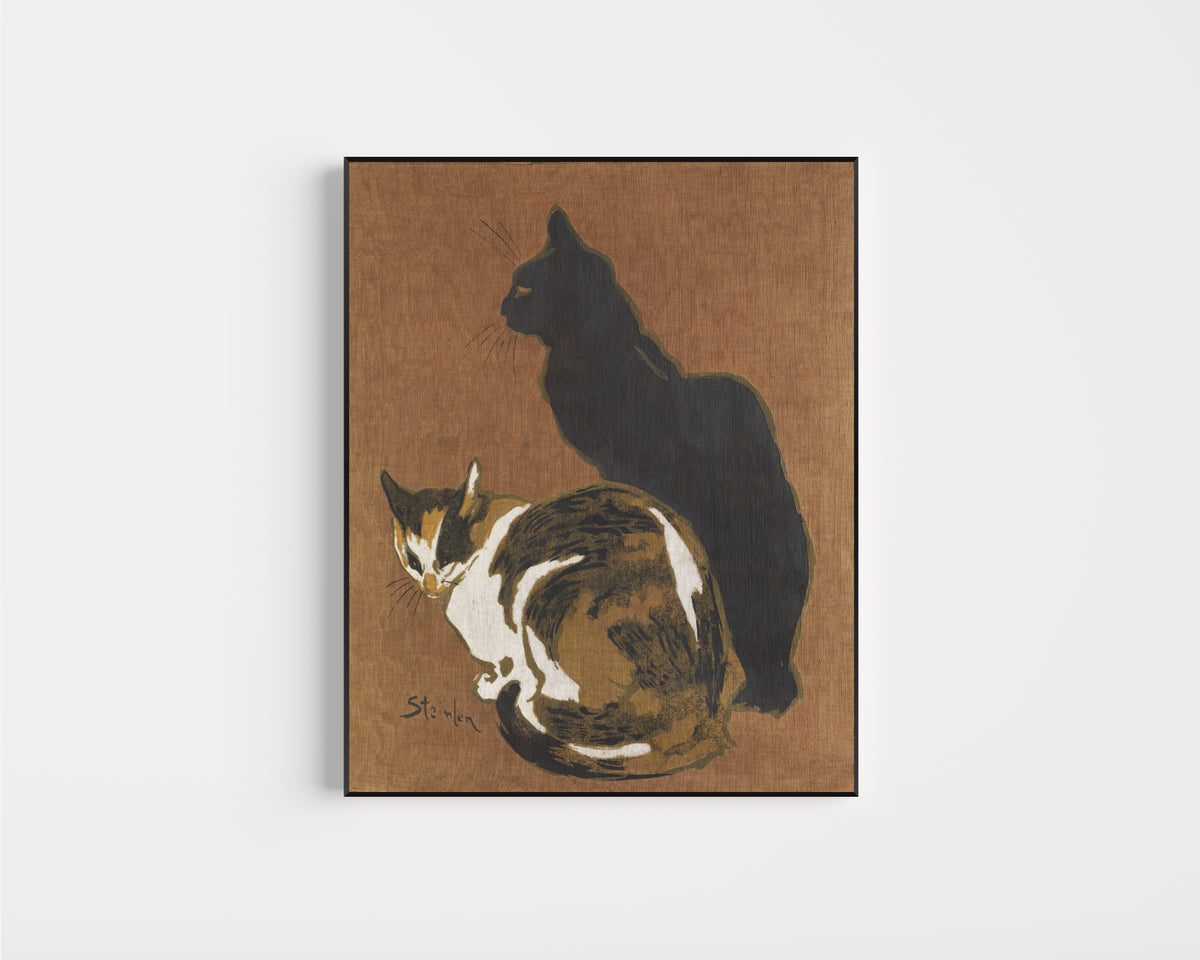 Framed art print of Two Cats by Théophile Steinlen, in a slim black frame on a plain white wall