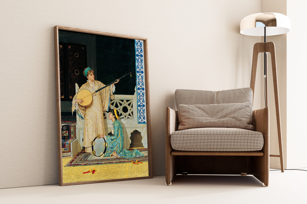 Two Musician Girls by Osman Hamdi Bey — framed and leaning against a wall beside an armchair and a floor lamp
