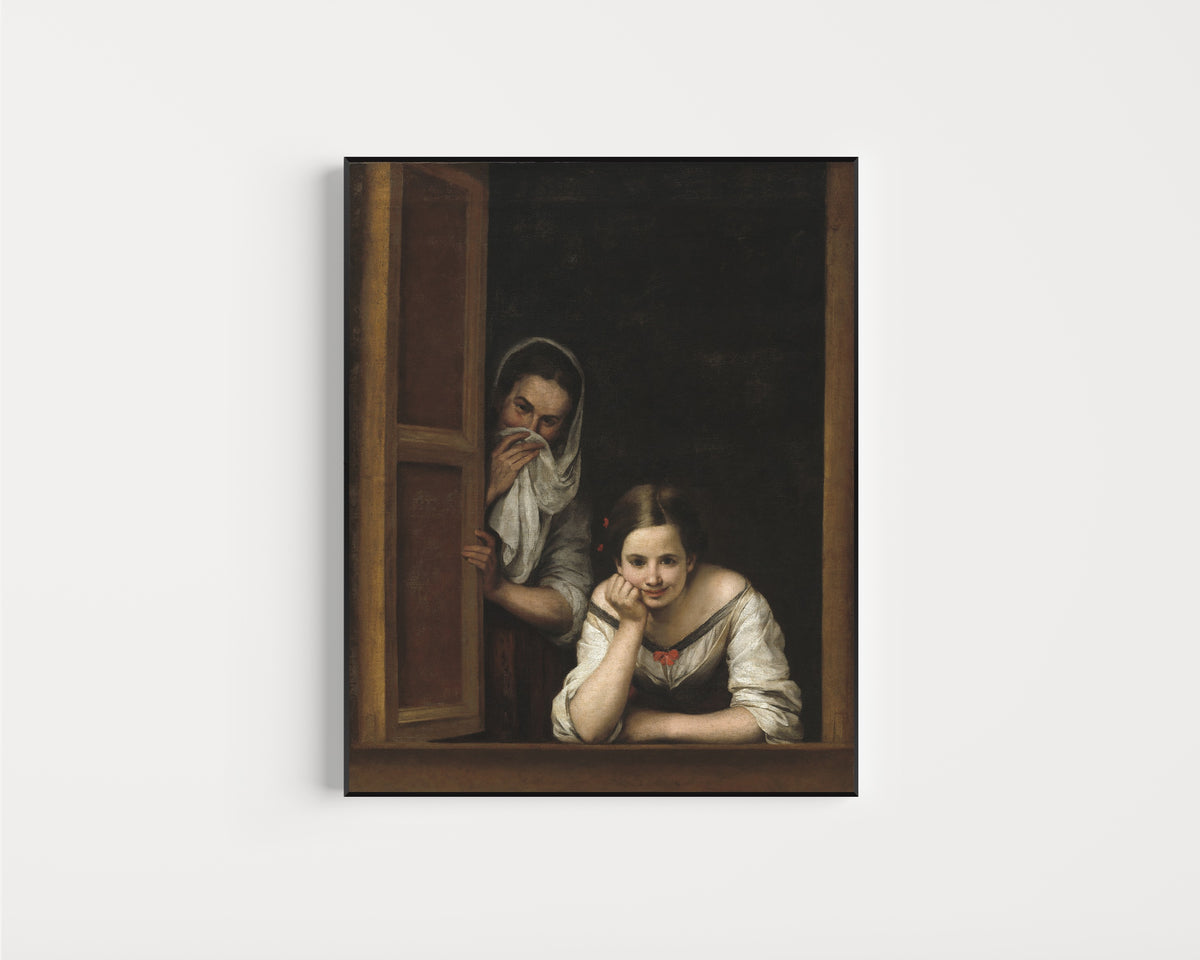 Framed art print of Two Women at a Window by Bartolomé Esteban Murillo, in a slim black frame on a plain white wall